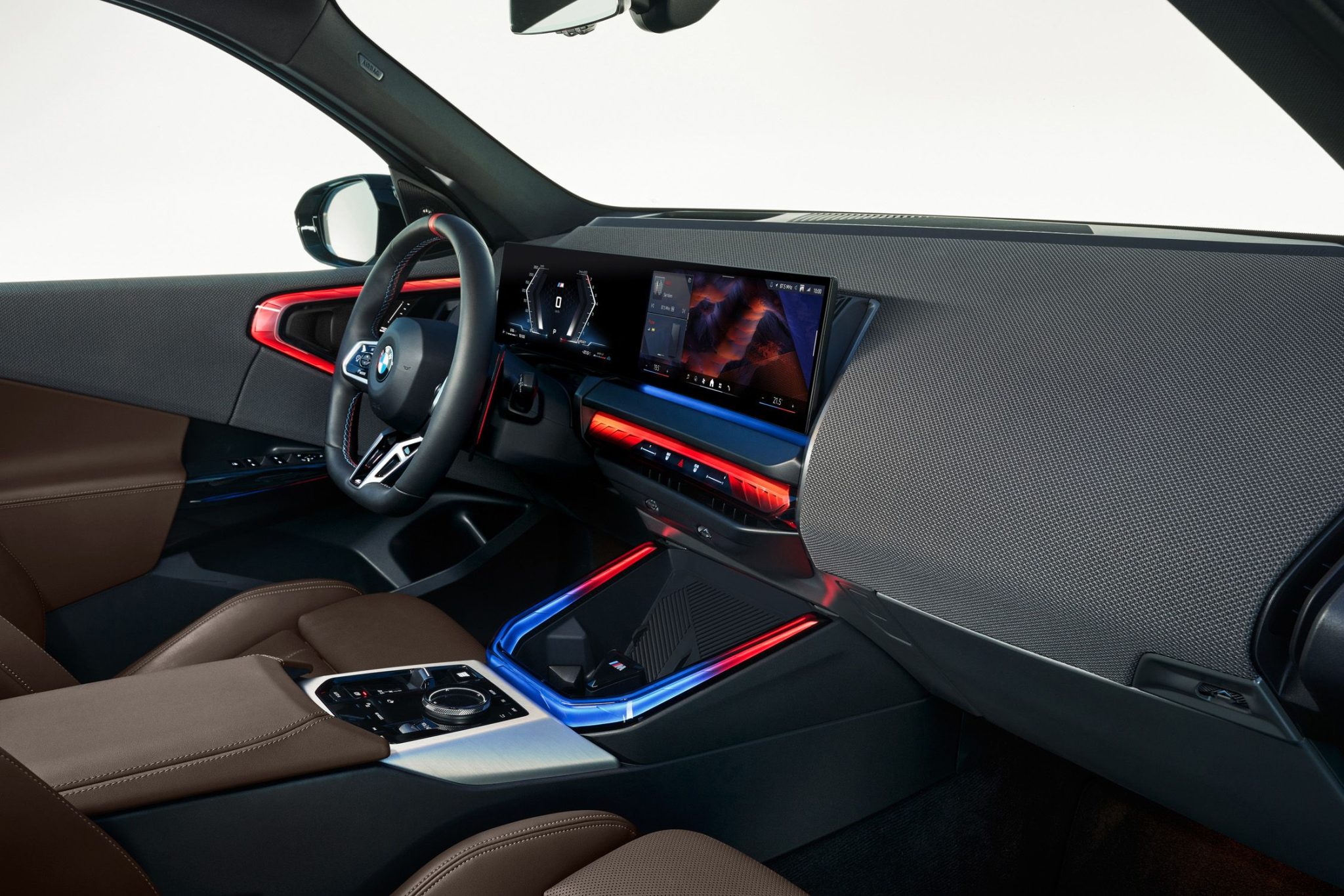 Another interior shot of the BMW X3 xDrive30i, showcasing its iDrive 8 system, ambient lighting, and spacious rear seats.