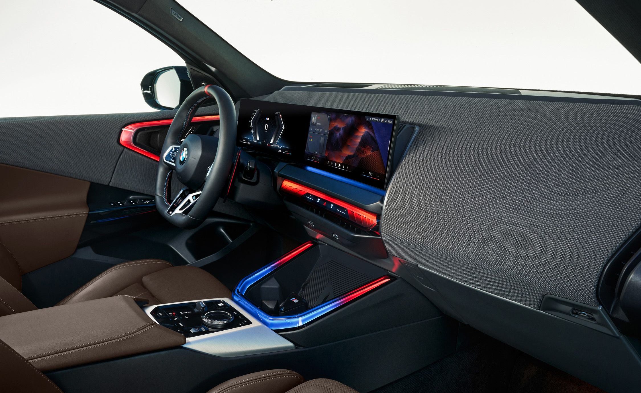 Another interior shot of the BMW X3 xDrive30i, showcasing its iDrive 8 system, ambient lighting, and spacious rear seats.