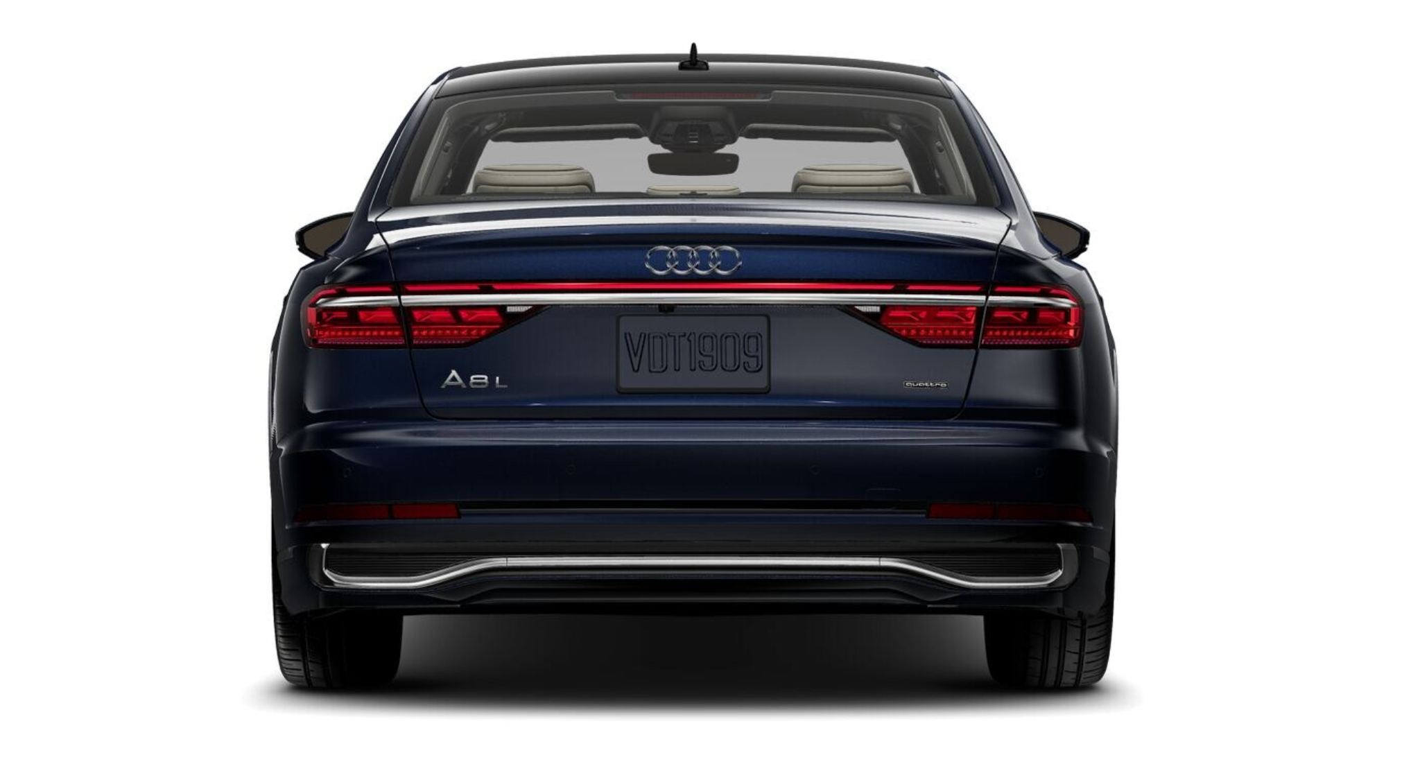 Sleek rear view of the 2025 Audi A8 L featuring dynamic OLED taillights, sculpted bumper, dual exhaust accents, and a bold Audi logo for a commanding road presence.