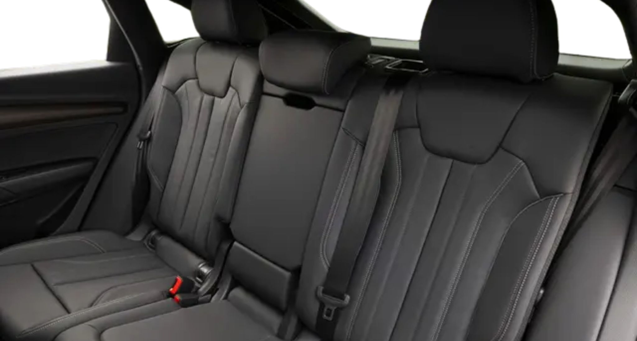 A spacious and luxurious rear interior of the 2025 Audi Q5, featuring premium black leather seats, contrast stitching, and ample legroom for comfort.