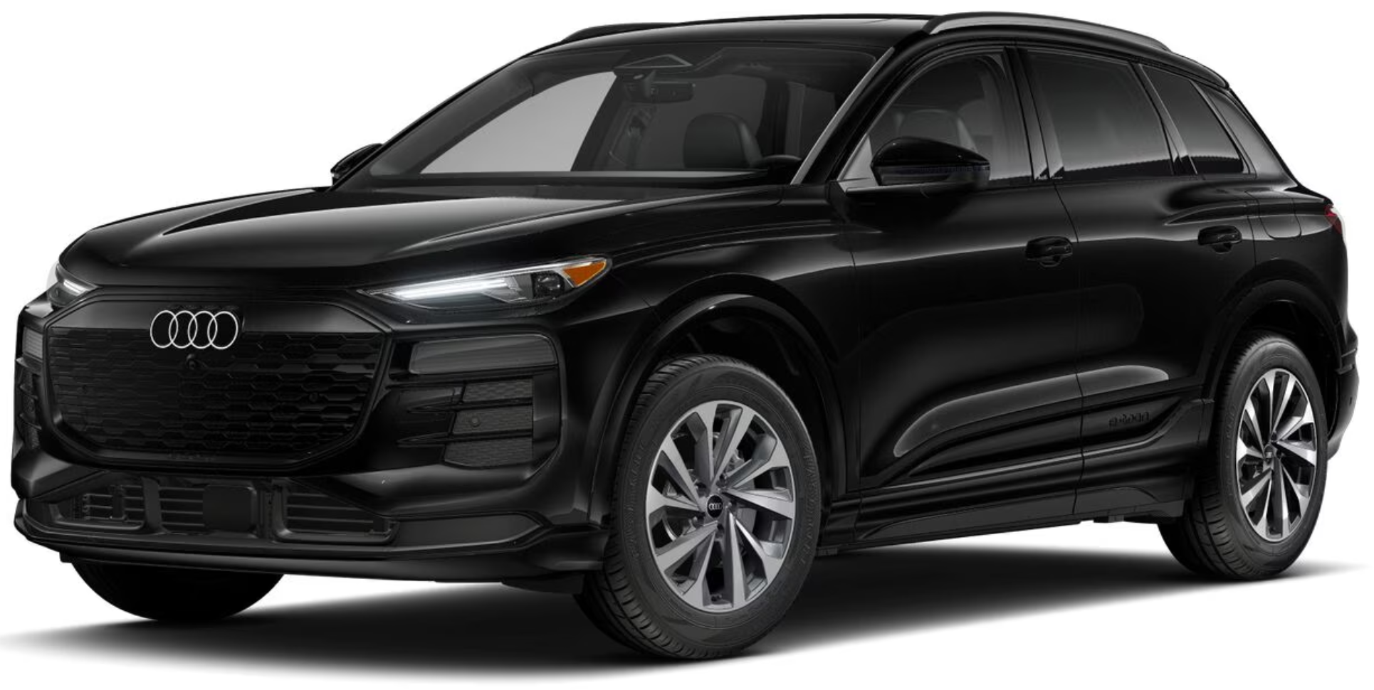 Front exterior view of the 2025 Audi Q6 e-tron with a bold grille, signature LED headlights, and a modern electric SUV design.