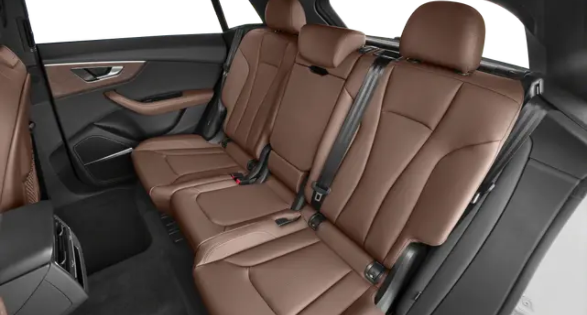 Luxury passenger seating of the 2025 Audi Q8 featuring premium brown leather upholstery, spacious legroom, and ergonomic comfort with advanced safety seatbelts.