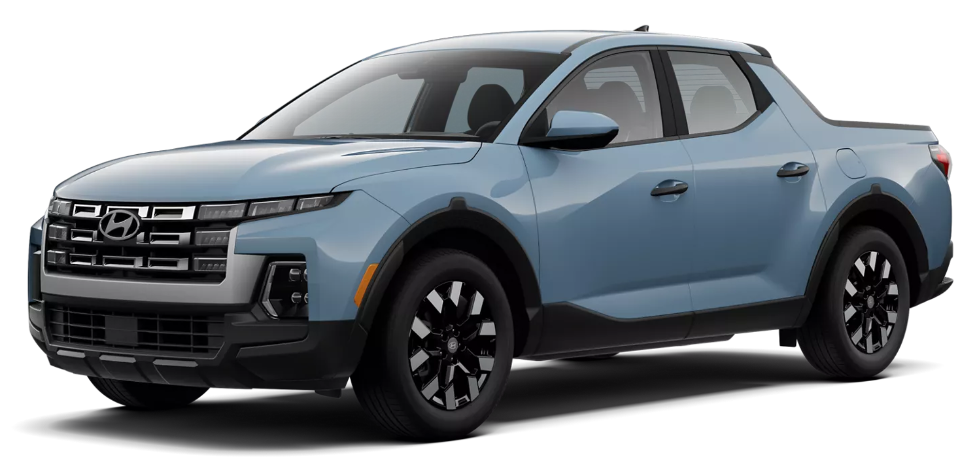 Front exterior of the 2025 Hyundai Santa Cruz SE featuring a wide grille with integrated LED headlights, aerodynamic hood design, and rugged front bumper.