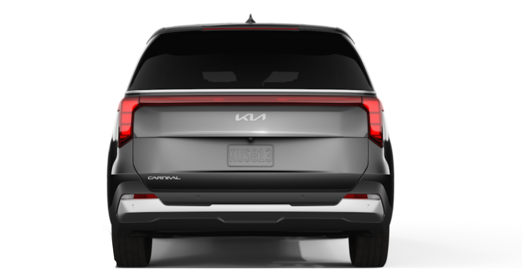 2025 Kia Carnival LX FWD rear exterior showcasing LED tail lights, rear spoiler, and SUV-inspired design with modern styling cues.