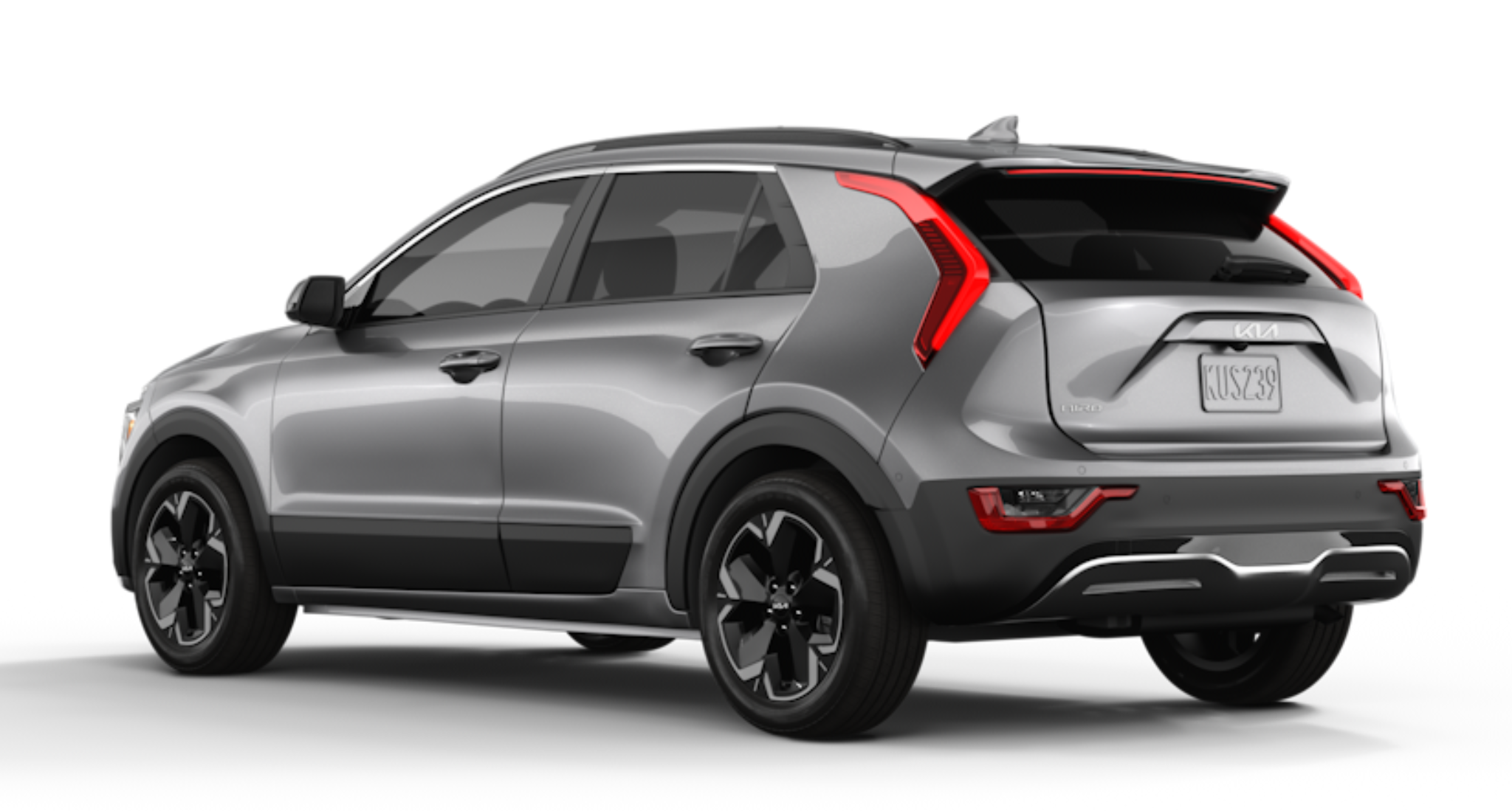 2025 Kia Niro EV Wind FWD rear exterior view in steel gray, featuring LED rear combination lights, gloss black cladding, and modern aerodynamic design.