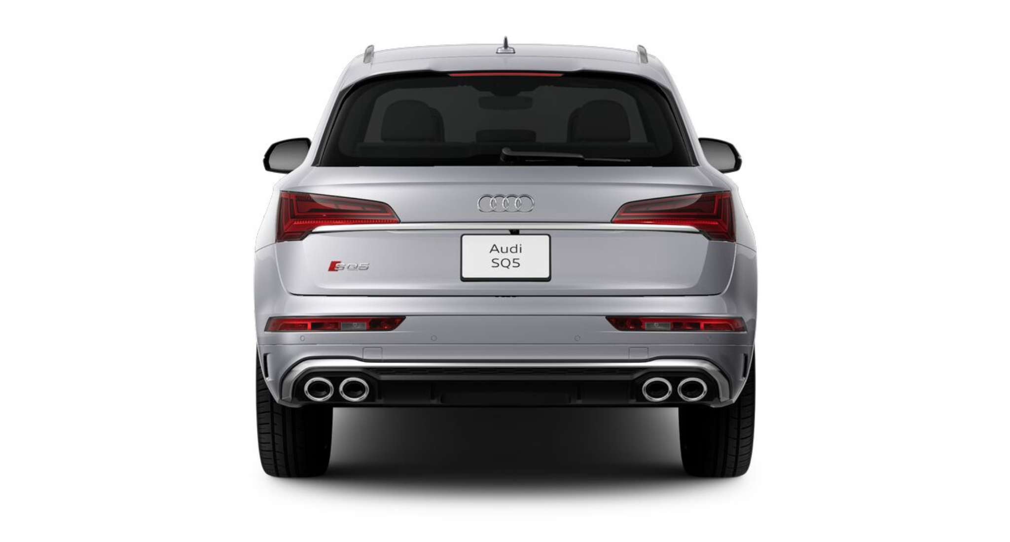 Rear exterior view of the 2025 Audi SQ5 in silver, highlighting quad exhaust outlets, LED tail lights, and sporty rear bumper design.