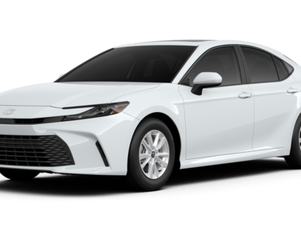 Angled front view of the 2025 Toyota Camry LE FWD, emphasizing its sculpted hood, aggressive grille, and contemporary design features.