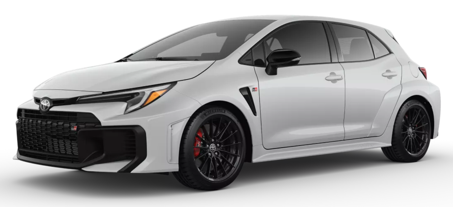 2025 Toyota GR Corolla Core Trim AWD in white, front three-quarter view showcasing its aggressive front grille, LED headlights, gloss-black alloy wheels, and sporty aerodynamic design.