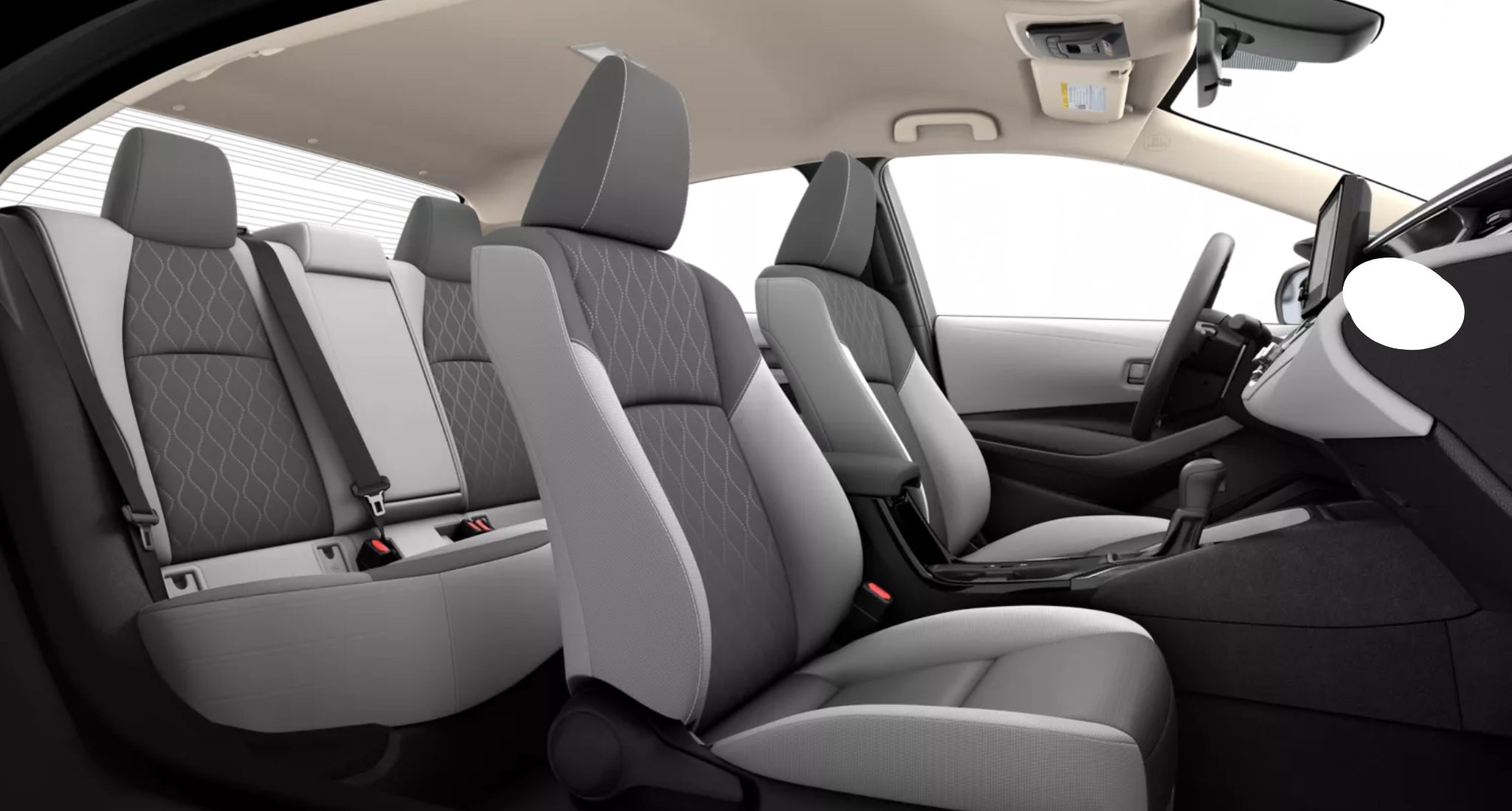 Rear view of the 2025 Toyota Corolla LE FWD interior showcasing premium fabric-trimmed seats and spacious rear legroom.