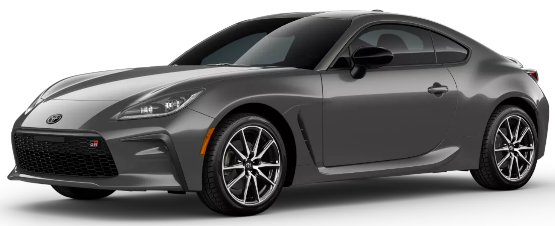2025 Toyota GR86 front three-quarter angle showing its aerodynamic design, sculpted body lines, 17-inch alloy wheels, and distinctive front grille with GR branding.