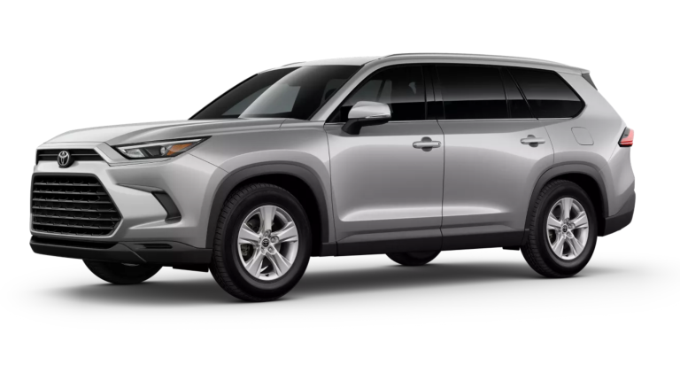 Angled side profile of the 2025 Toyota Grand Highlander LE in silver, showcasing its sleek body lines, alloy wheels, and spacious SUV dimensions.