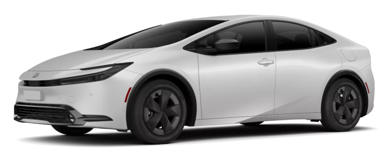 2025 Toyota Prius Hybrid LE shown from the front side angle in white, featuring bold 17-inch alloy wheels, aerodynamic body lines, and a modern hybrid sedan profile.