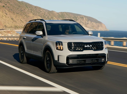 2025 Kia Telluride driving on the road demonstrating all-wheel drive and versatility.
