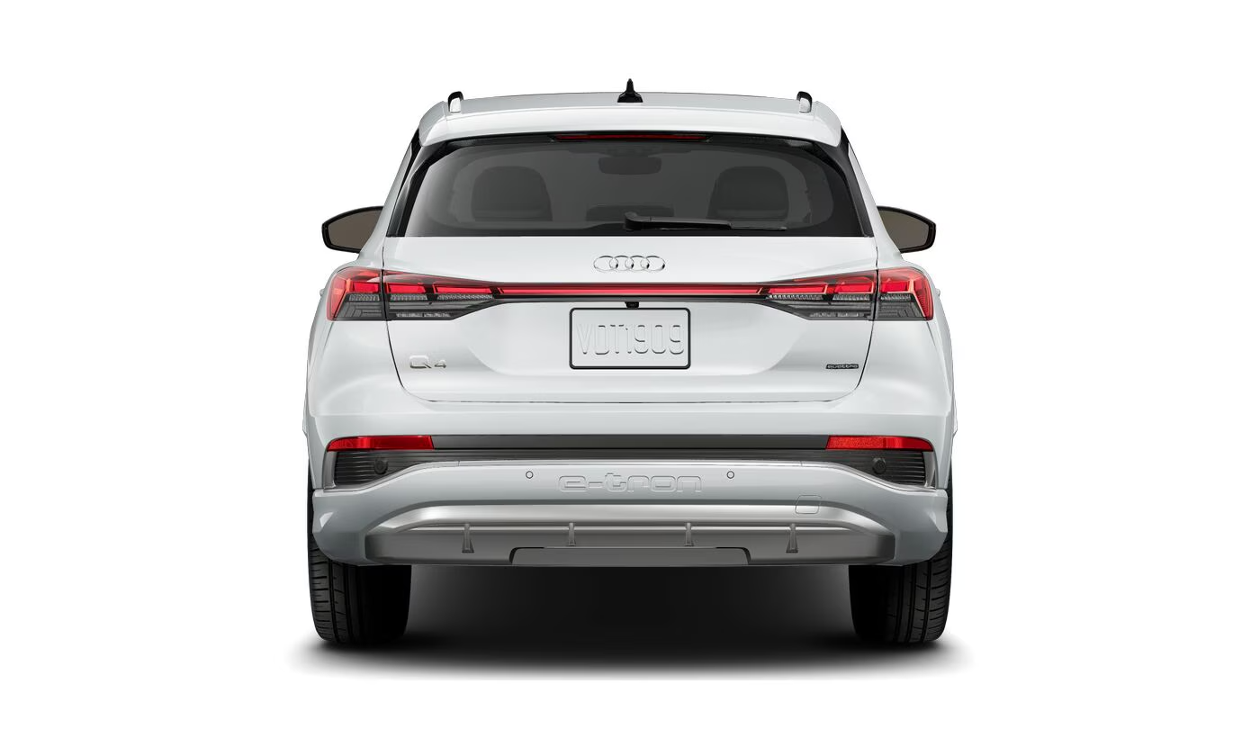 Rear view of the 2025 Audi Q4 e-tron, highlighting its aerodynamic design, sleek LED taillights, and electric SUV styling in a glossy white finish.