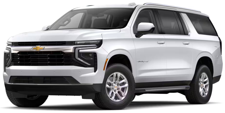 Front view of the 2025 Chevrolet Suburban LS 4WD featuring its aggressive grille, LED headlights, and Chevrolet emblem.