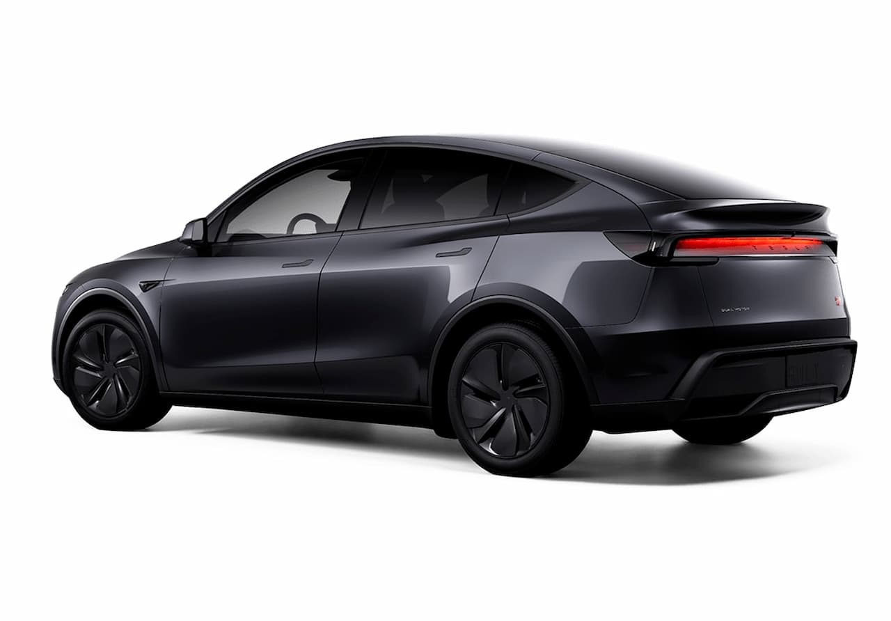 Streamlined side profile of the 2025 Tesla Model Y AWD in midnight black, highlighting its coupe-like roofline and flush door handles.