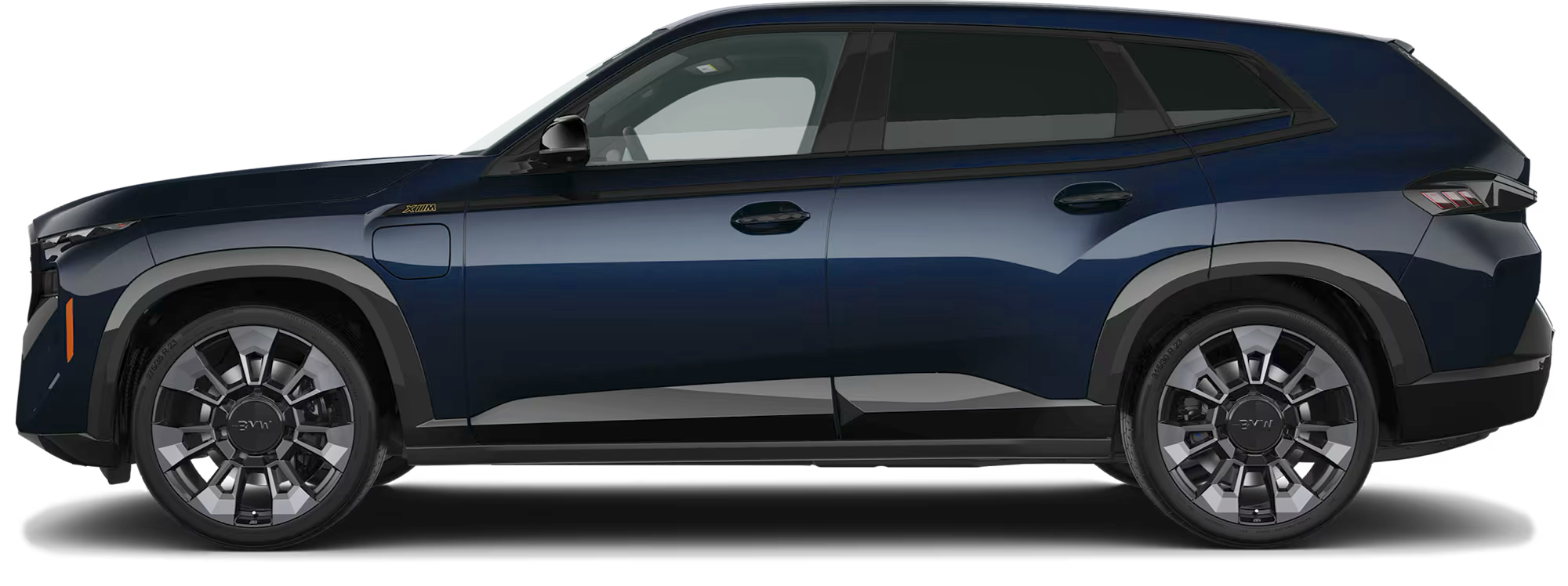 Side view of the 2025 BMW XM PHEV AWD featuring aerodynamic body lines, M alloy wheels, and charging port detail.