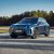 2026 BMW iX Review: Front view of luxury electric SUV with illuminated kidney grille.